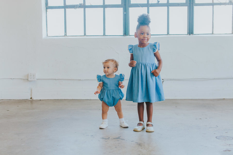 Infant Girl's Denim Chambray Romper with Pom Pom Trim