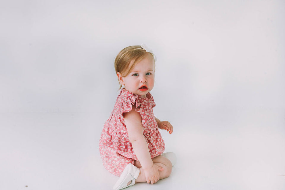 pink and white ditsy floral print romper