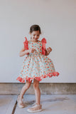 little girl's red gingham and floral pinafore dress