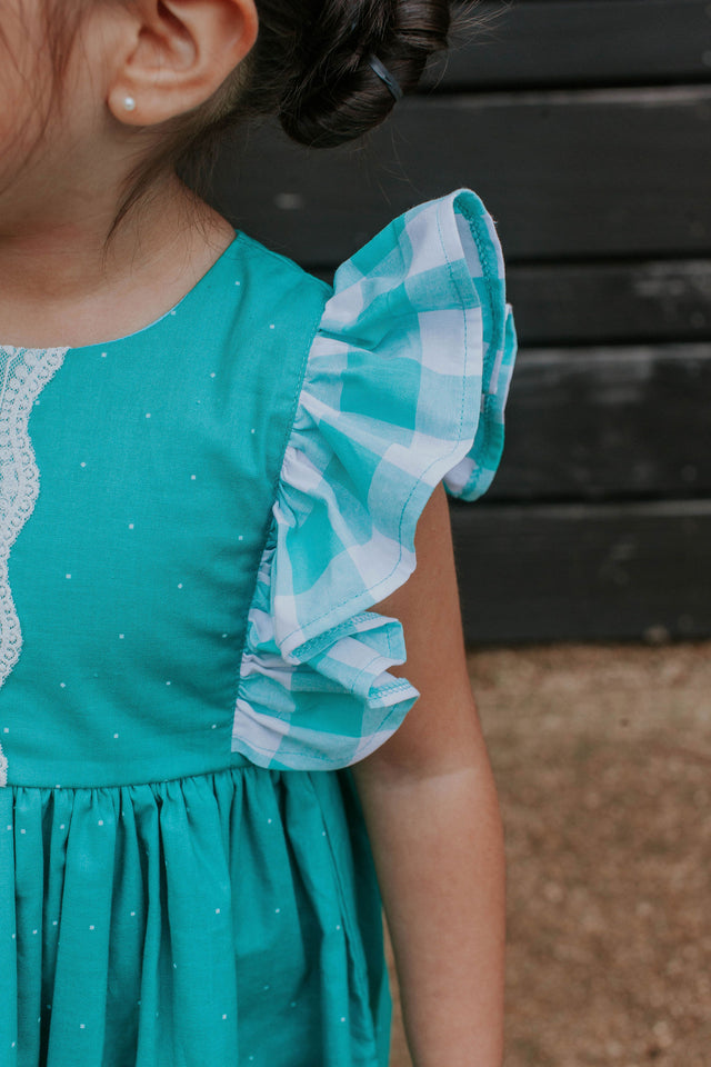 little girls turquoise dress with plaid ruffle sleeves