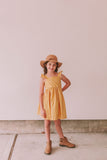 Little Girl's Yellow and White Ditsy Floral Flutter Sleeve Sun Dress. The perfect vintage inspired mustard yellow floral print dress to make any special occasion magical! This flutter sleeve twirl dress features a gorgeous calico floral print that makes this the perfect 2022 sun dress for girls!