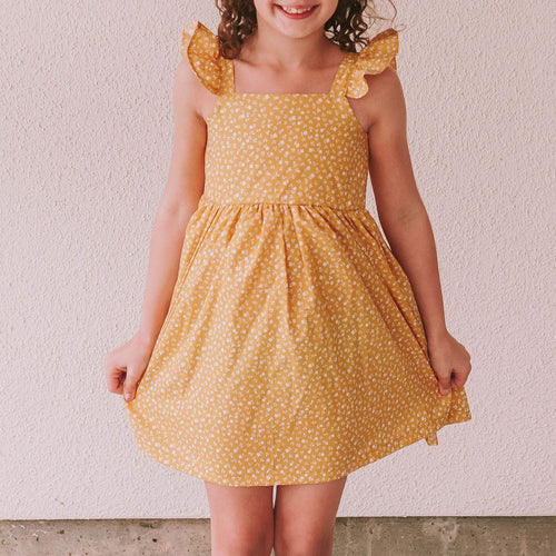 Little Girl's Yellow and White Ditsy Floral Flutter Sleeve Sun Dress. The perfect vintage inspired mustard yellow floral print dress to make any special occasion magical! This flutter sleeve twirl dress features a gorgeous calico floral print that makes this the perfect 2022 sun dress for girls!