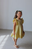 little girls yellow ruffled dress