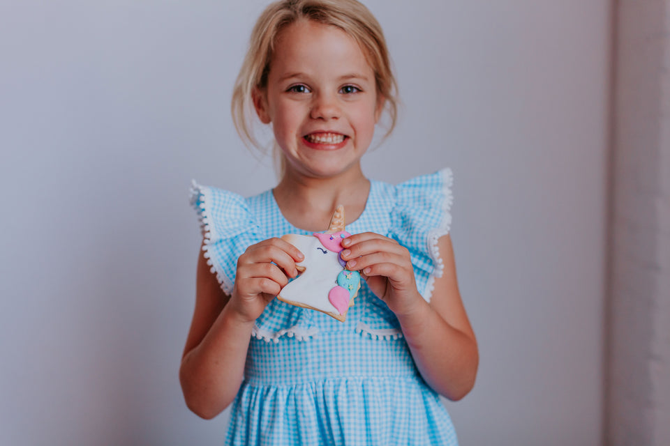 Little Girl's Blue Gingham Pinafore Dress with Pom Pom Trim