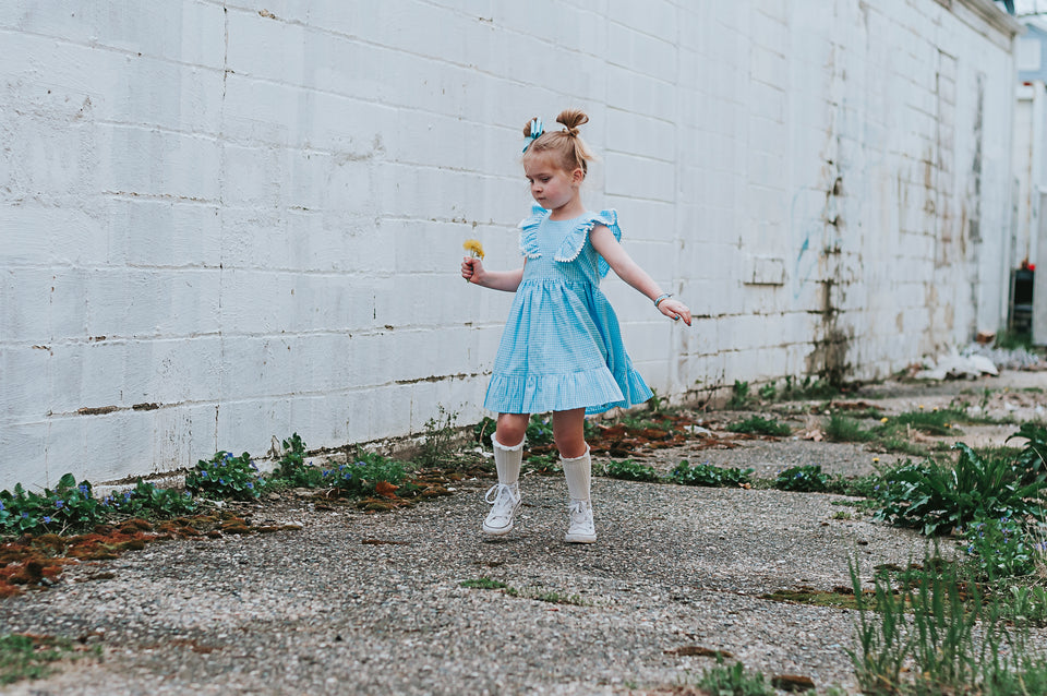 Little Girl's Blue Gingham Pinafore Dress with Pom Pom Trim